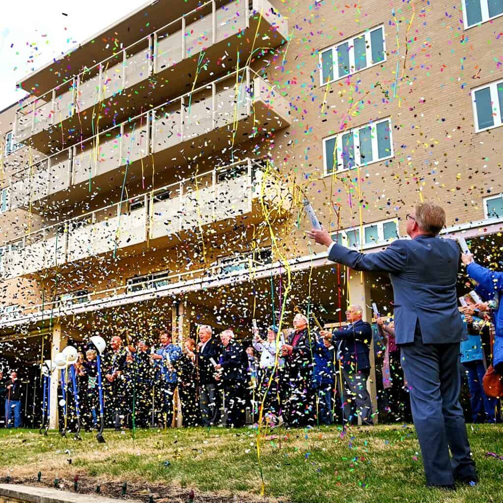 Topeka Chamber of Commerce President Curtis Sneden leads the SkyBreaking with confetti cannons and streamers to begin the Redwood Rennovation project.